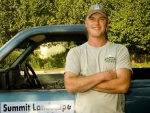 Dave Macdonald, founder of Summit Landscape, standing in front of his work truck